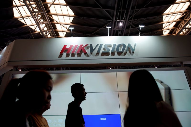 FILE PHOTO: People visit a HIKVision booth at the security