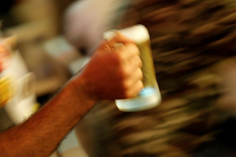 FILE PHOTO: A waiter carries a beer mug at a