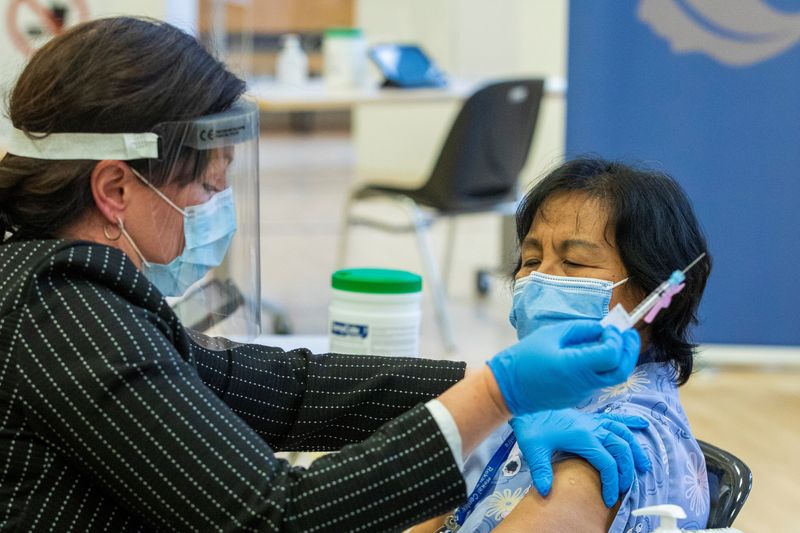 FILE PHOTO: A healthcare worker administers a Pfizer/BioNTEch coronavirus disease