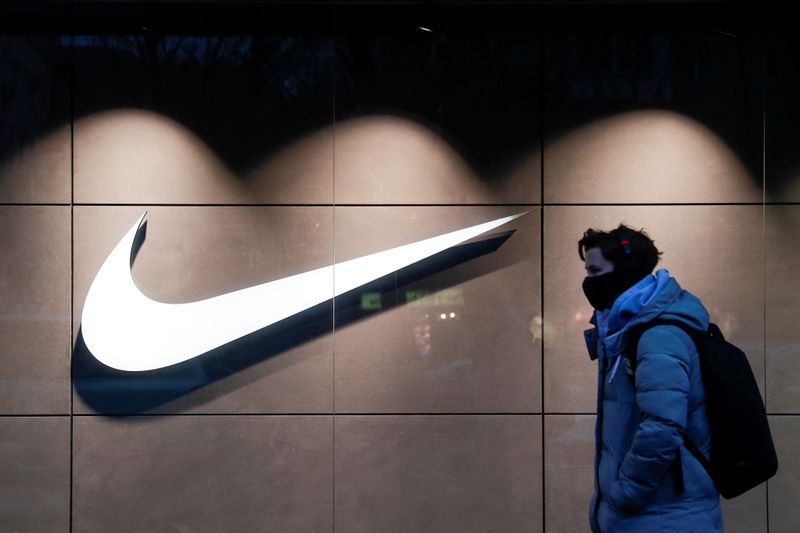 FILE PHOTO: A person walks past a Nike brand store
