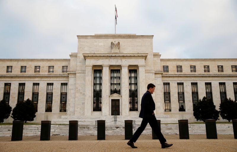 A man walks past the Federal Reserve Bank in Washington