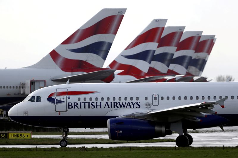 FILE PHOTO: A British Airways plane taxis past tail fins
