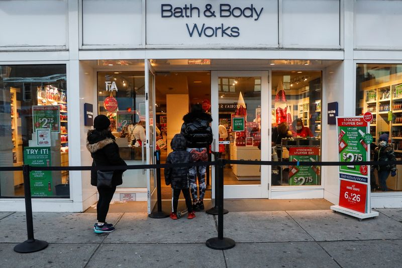 Shoppers wait in line outside a Bath and Body Works