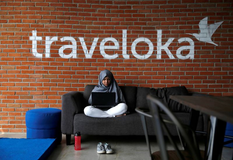 FILE PHOTO: An employee of Traveloka works at the company’s
