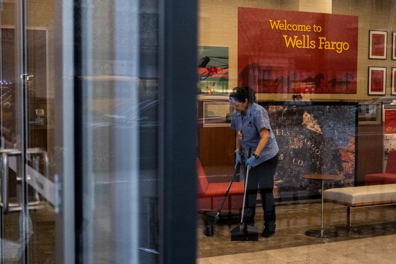 FILE PHOTO: A staff cleans the lobby inside Wells Fargo