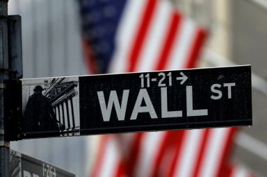 FILE PHOTO: Raindrops hang on a sign for Wall Street