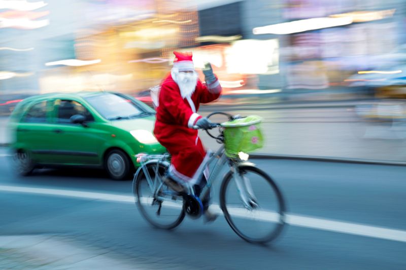 FILE PHOTO: ‘Santa Claus’ rides a bike on city street