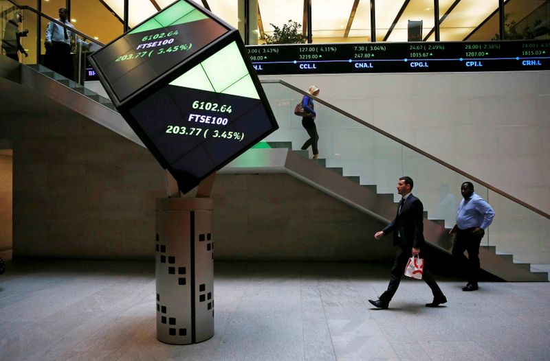 People walk through the lobby of the London Stock Exchange