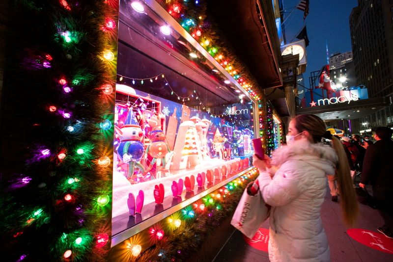 FILE PHOTO: A woman takes pictures of Christmas window at