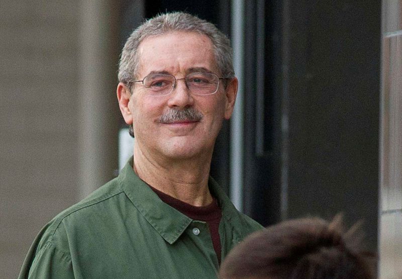 FILE PHOTO: Allen Stanford smiles as he waits to enter