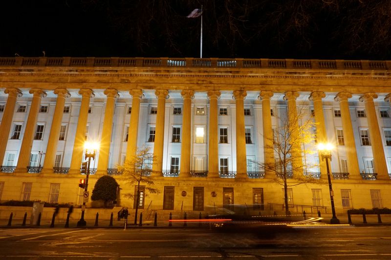 A vehicle drives past the U.S. Treasury Department in Washington