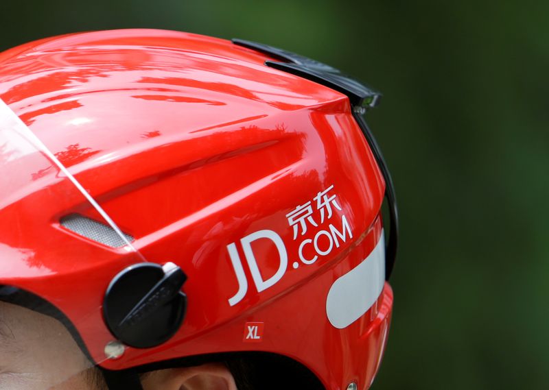Logo of JD.com is seen on a helmet of a