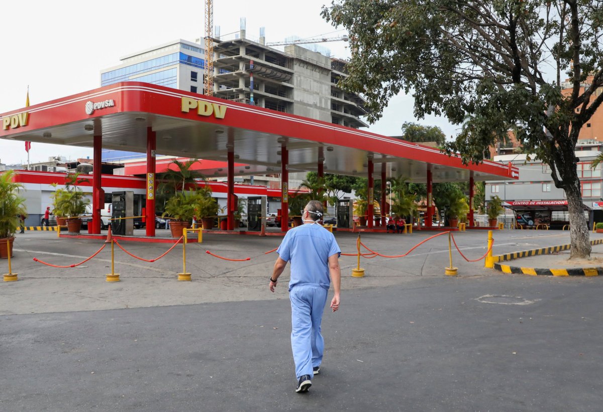 FILE PHOTO: A doctor walks near a closed gas station