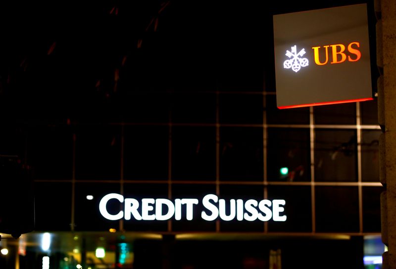 FILE PHOTO: Logos of Swiss banks UBS and Credit Suisse