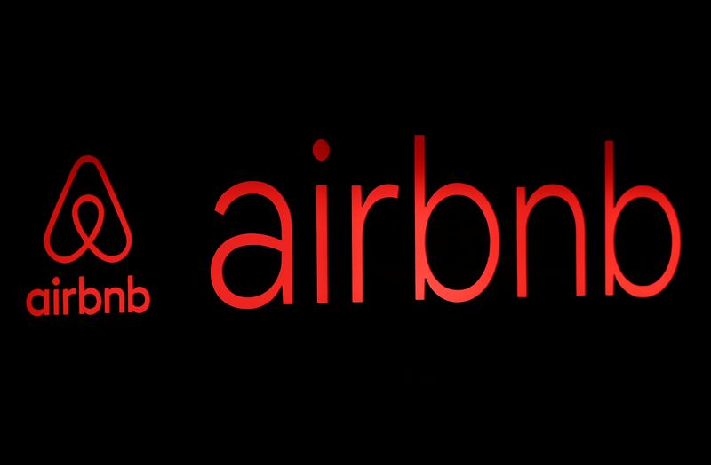 The logos of Airbnb are displayed at an Airbnb event
