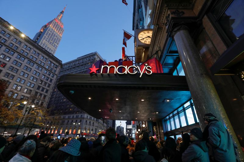 People wait to enter Macy’s Herald Square ahead of early
