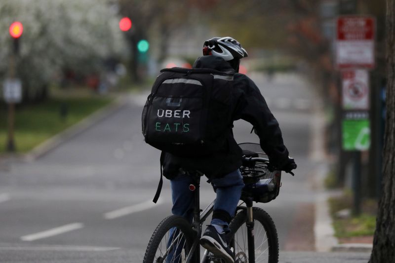 An Uber Eats bicyclist makes a delivery during the coronavirus