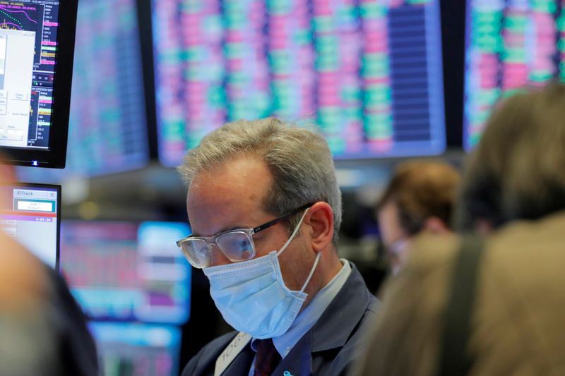 FILE PHOTO: A trader wears a mask as he works
