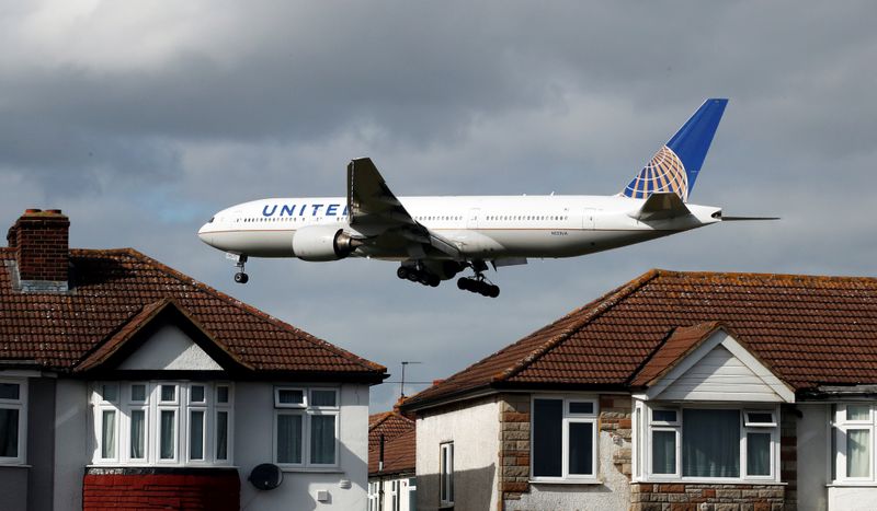 A United Airlines passenger aircraft arrives over the top of