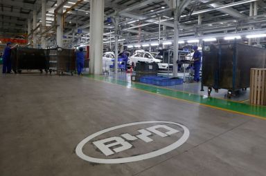 A logo of BYD is painted inside an assembly line
