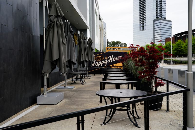 An empty patio is seen outside a closed restaurant days