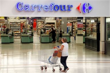 FILE PHOTO: A customer pushes a shopping trolley as she