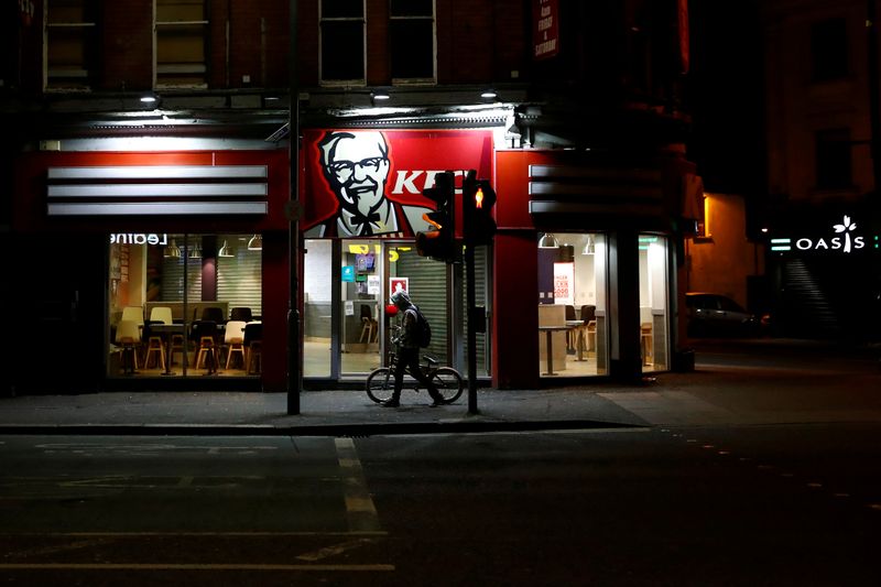 FILE PHOTO: A person walks past an empty KFC restaurant