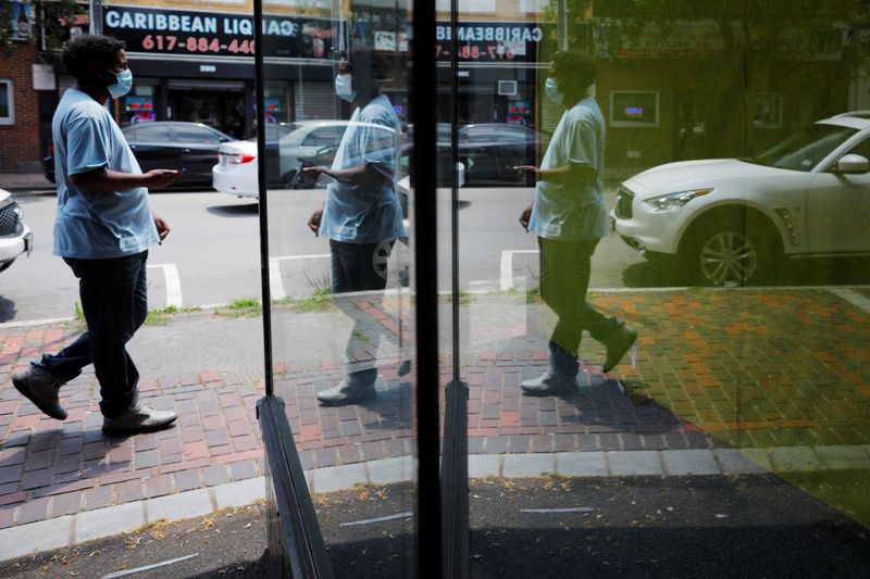A pedestrian is reflected in the window of an empty