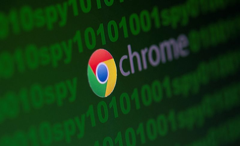 FILE PHOTO: Google Chrome logo is seen near cyber code