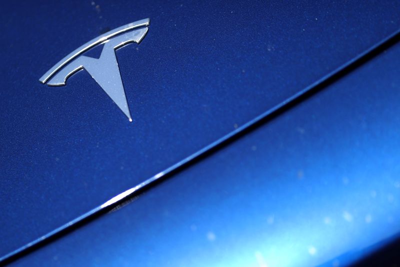 The Tesla logo is seen on a car in Los