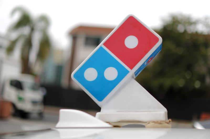 A Domino’s Pizza sign sits on the top of a