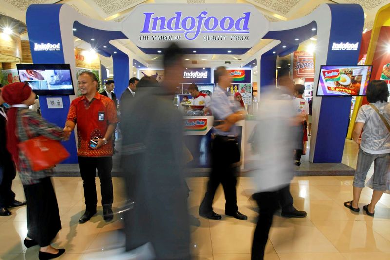FILE PHOTO: Visitors walk past the booth of Indonesian food
