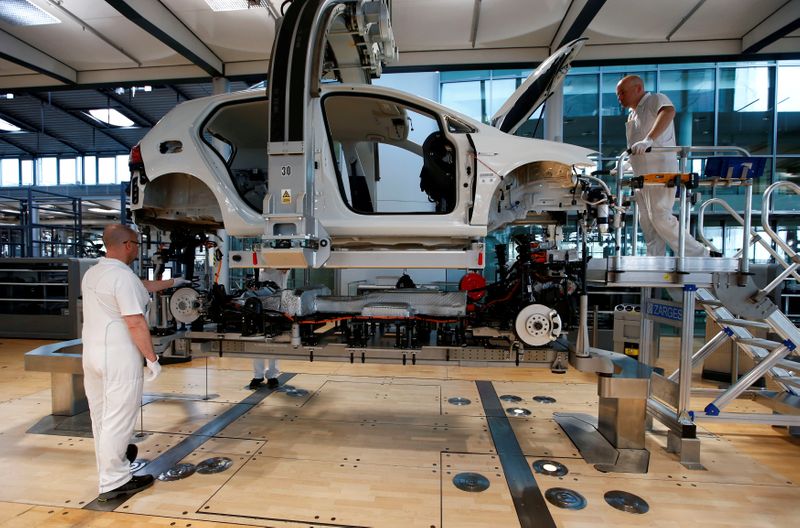 FILE PHOTO: Workers assemble a VW e-Golf electric car in