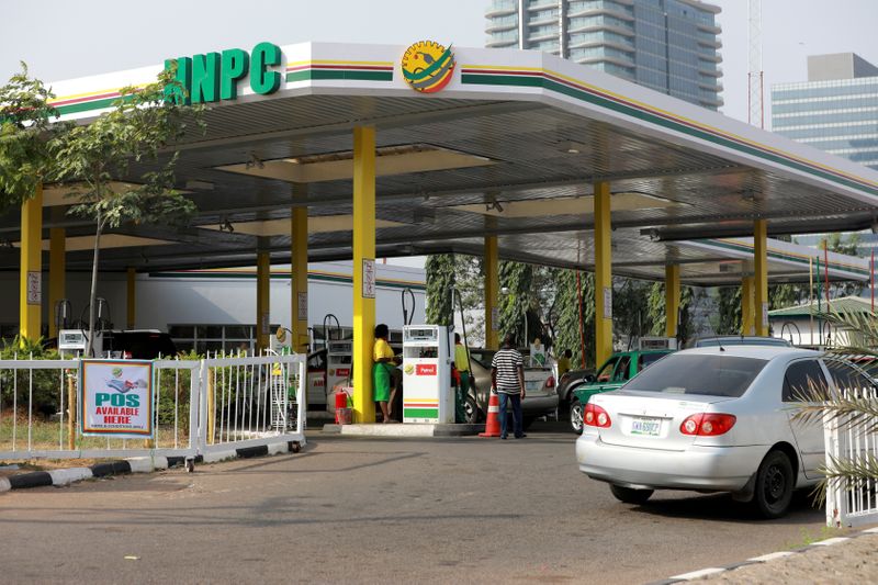 FILE PHOTO: Cars queue to buy petrol at the NNPC