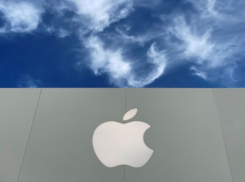 The Apple logo is shown atop an Apple store at
