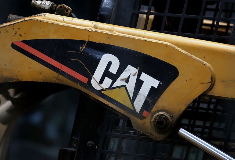 A Caterpillar logo is pictured on the skid-steer loader at