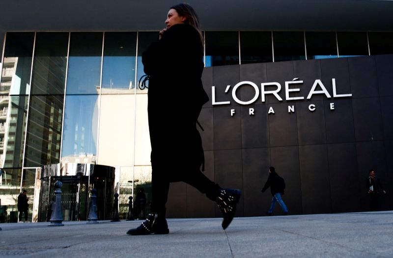 FILE PHOTO: A woman walks by the logo of French