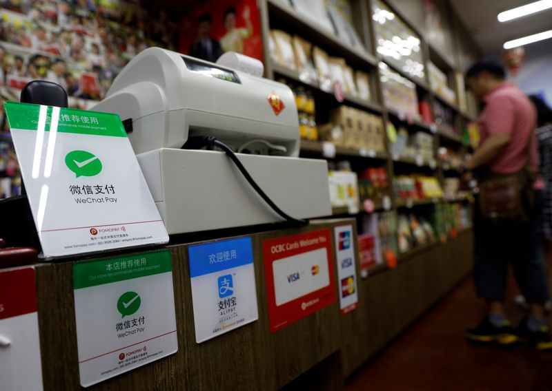 Signs accepting WeChat Pay and AliPay are displayed at a