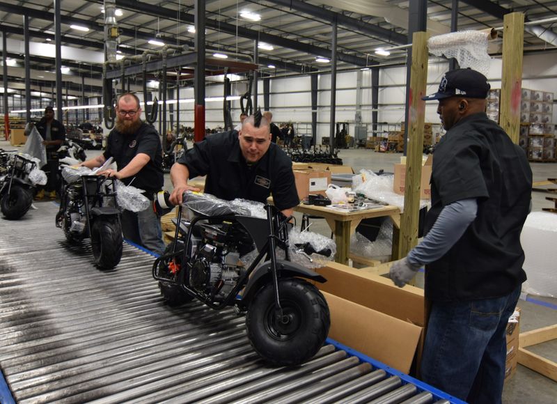 Workers construct mini-bikes at motorcycle and go-kart maker Monster Moto