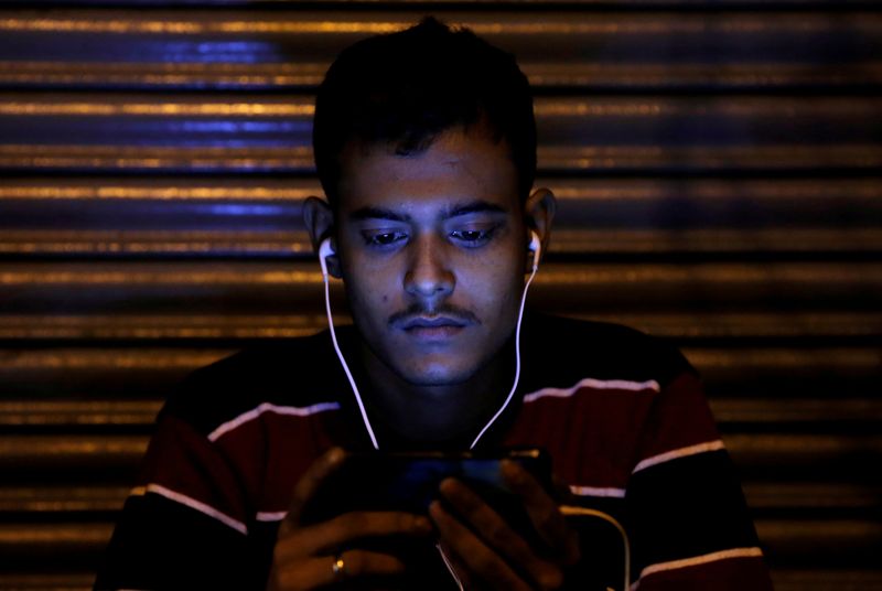 FILE PHOTO: A man watches a movie on his phone