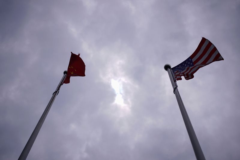 FILE PHOTO: Chinese and U.S. flags flutter in Shanghai