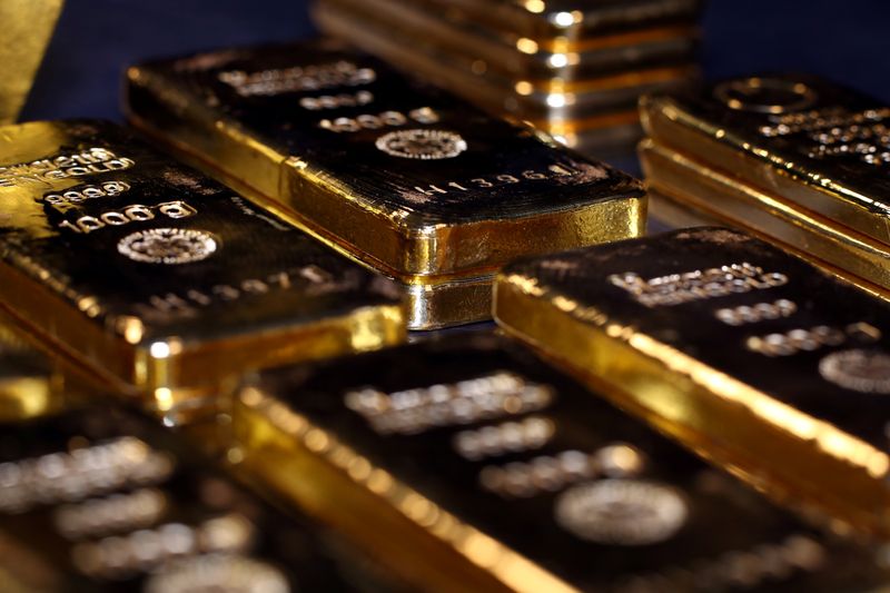 FILE PHOTO: Gold bars and coins are stacked in the
