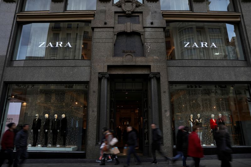 FILE PHOTO: People walk past a Zara store, an Inditex