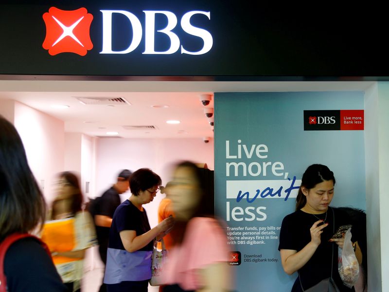 FILE PHOTO: FILE PHOTO: People walk past a DBS branch