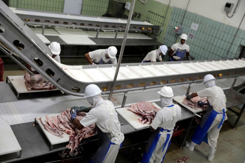 Employees work at the assembly line of jerked beef at