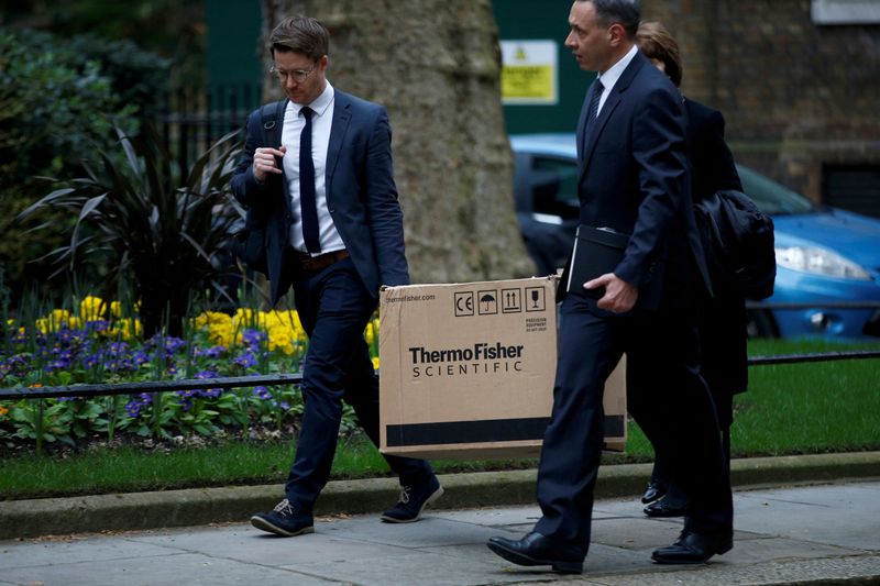 FILE PHOTO: People carrying a box from ThermoFisher Scientific, a