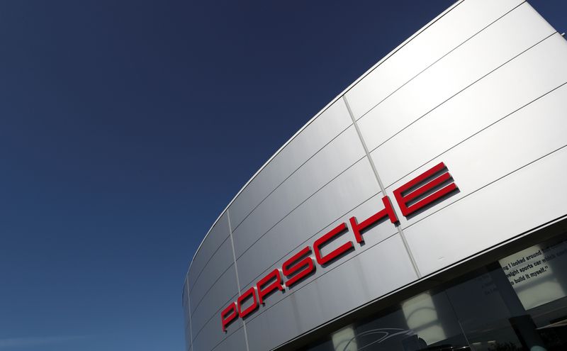 A logo of Porsche is seen outside a Porsche car