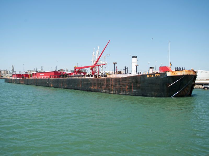 FILE PHOTO: A seagoing barge is loaded with crude oil