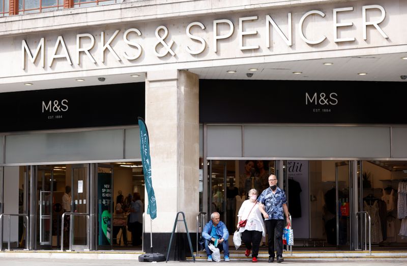 People walk outside the Marks&Spencer shop amid the outbreak of