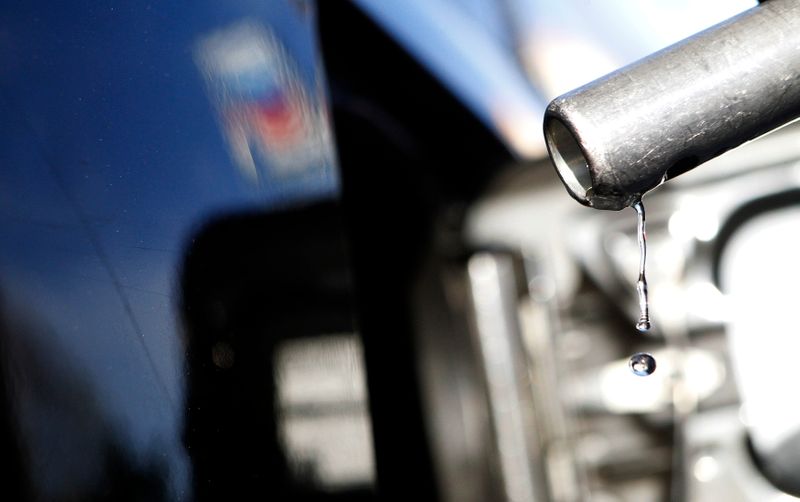 Gasoline drips off a nozzle during refueling at a gas